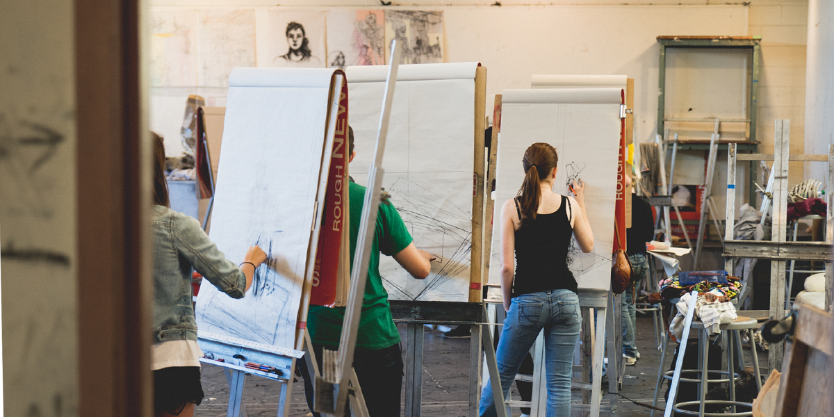 Students drawing at easels in the studio
